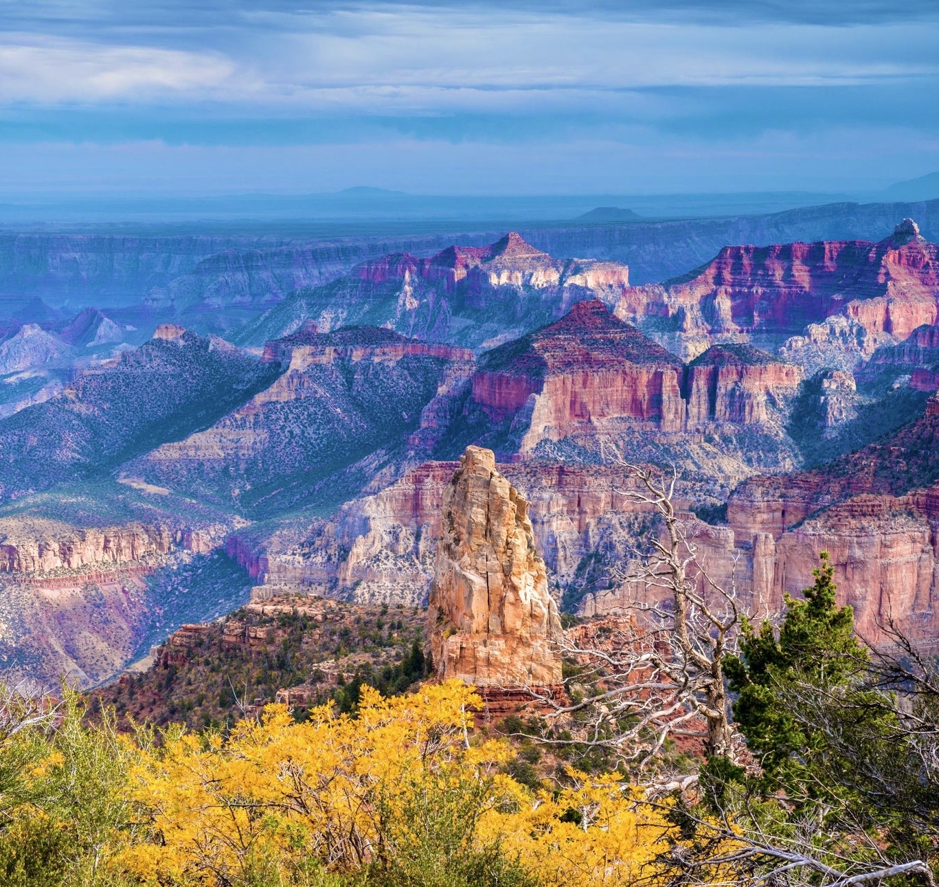 Layered canyon walls and a rock spire in the Grand Canyon