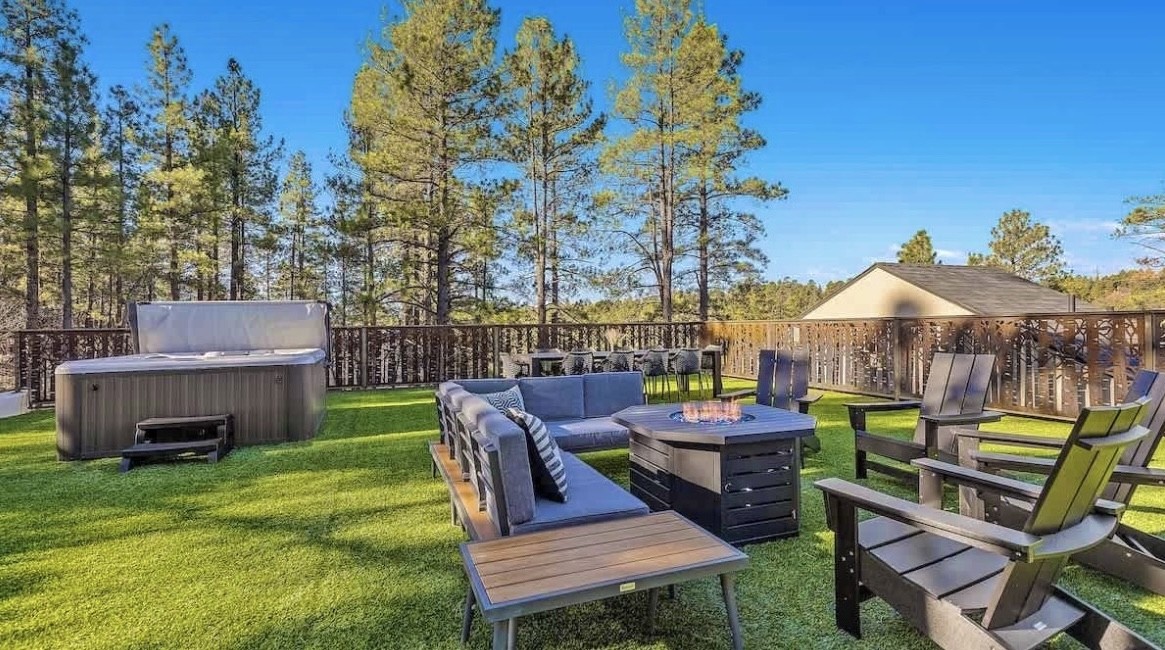 The private rooftop with a hot tub, fire pit, and lounge seating